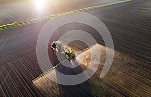 Tractor spraying soil in field