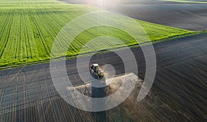 Tractor spraying soil in field