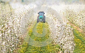 Tractor sprays insecticide photo
