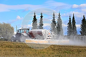 Tractor Spreading Agricultural Lime in Field