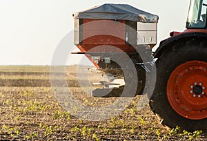 Tractor spreading artificial fertilizers