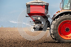 Tractor spreading artificial fertilizers