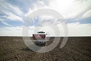 Tractor spreading artificial fertilizers