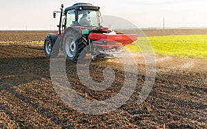 Tractor spreading artificial fertilizers