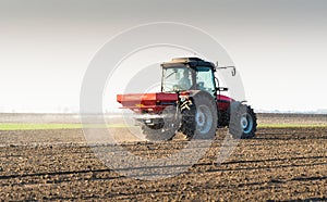 Tractor spreading artificial fertilizers