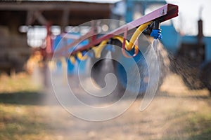 Tractor sprinkles the pesticides