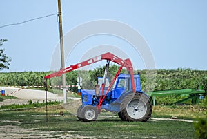 Tractor, standing in a row. Agricultural machinery.