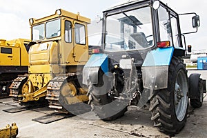 Tractor, standing in a row. Parking of agricultural machinery.