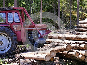 a tractor stands by a pile of lumber