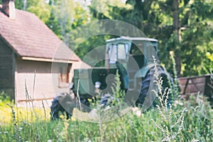A tractor stands at a rural house