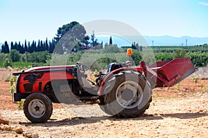 A tractor stopped on a dirt road near the workplace