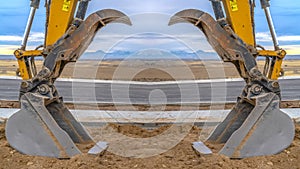 Tractor symmetry with open scooper on an excavator