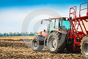 Tractor with tanks in the field. Agricultural machinery and farming.