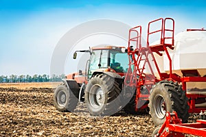 Tractor with tanks in the field. Agricultural machinery and farming.