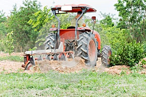 Tractor tilling in field