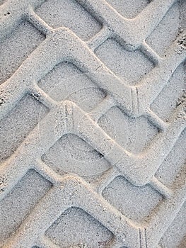 Tractor tire prints in sand at the beach