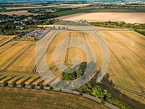 Tractor tracks in the field, Asphalt road in the mountains