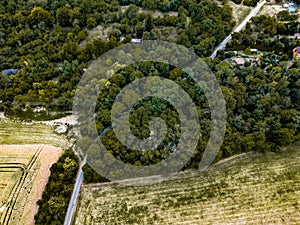 Tractor tracks in the field, Asphalt road in the mountains