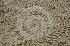 Tractor tracks on sand beach