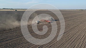 Tractor with trailed agricultural machinery plowing and apply fertilizers