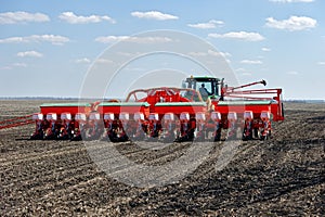 Tractor with trailed planter on the field