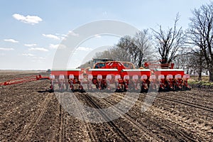Tractor with trailed planter on the field