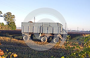 Tractor trailer on farm field in autumn morning