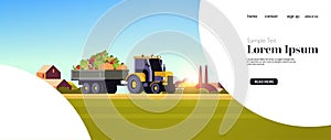 Tractor with trailer full of fresh ripe harvested vegetables organic food seasonal products harvesting concept farmland