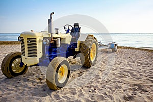 Tractor with trailer for transport boats on the sandy beach