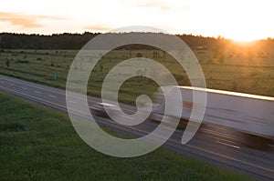 Tractor Trailor in Motion at Sunset