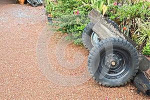 Tractor wheels spare parts on dirt way in front of home