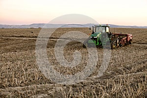 A tractor and wind rower harvesting Idaho potatoes.