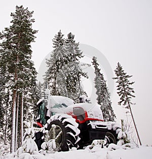 Tractor in winter forest