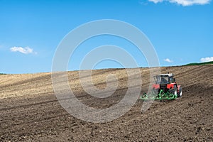 Tractor working in farm fields, rural landscape