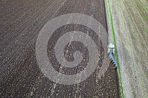 Tractor working in the field. Aerial view.