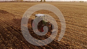 Tractor working on field after harvesting.