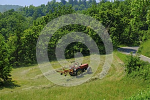Tractor working in the field. Hay bailing, hay harvesting. Agricultural industry