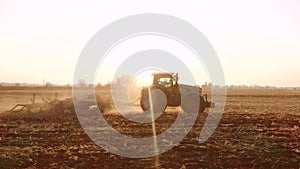 Tractor working on field at sunrise.