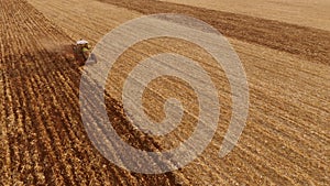 Tractor working on the field, top view.