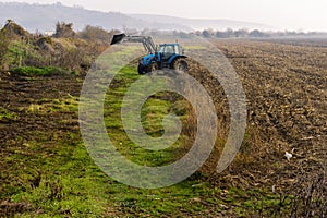 Tractor working in the field on the way to the village of Asparuhovo.