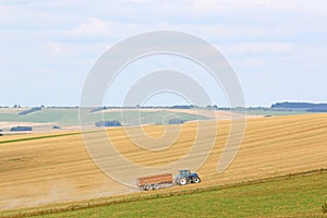 Tractor working Fields of the Pewsey Vale, Wiltshire at harvest