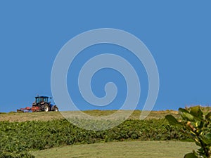 Tractor working lonely in the field