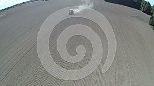 Tractor working on sowed autumn field, aerial view