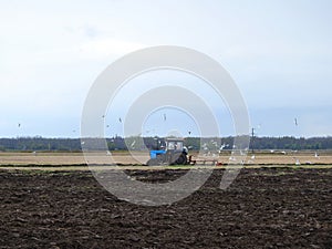 Tractor working in spring field, Lithuania