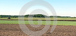 Tractor working in spring field, Lithuania