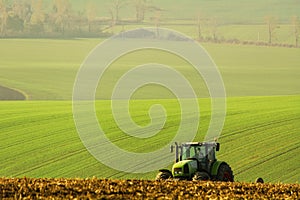The tractor works the land. Claas Ares 836 RZ