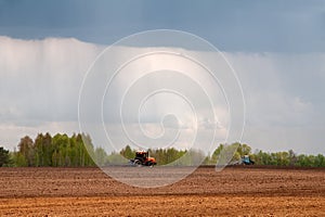 Tractors cultivating the land