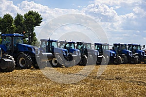 Tractors in the field, aligned in a row