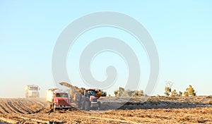 Tractors and field implements harvest potatoes in Idaho.