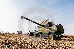 On tractors harvesting wheat field against